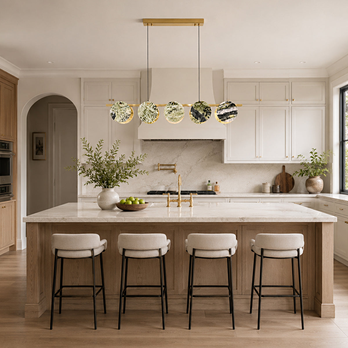 Green marble disc linear chandelier above a contemporary island