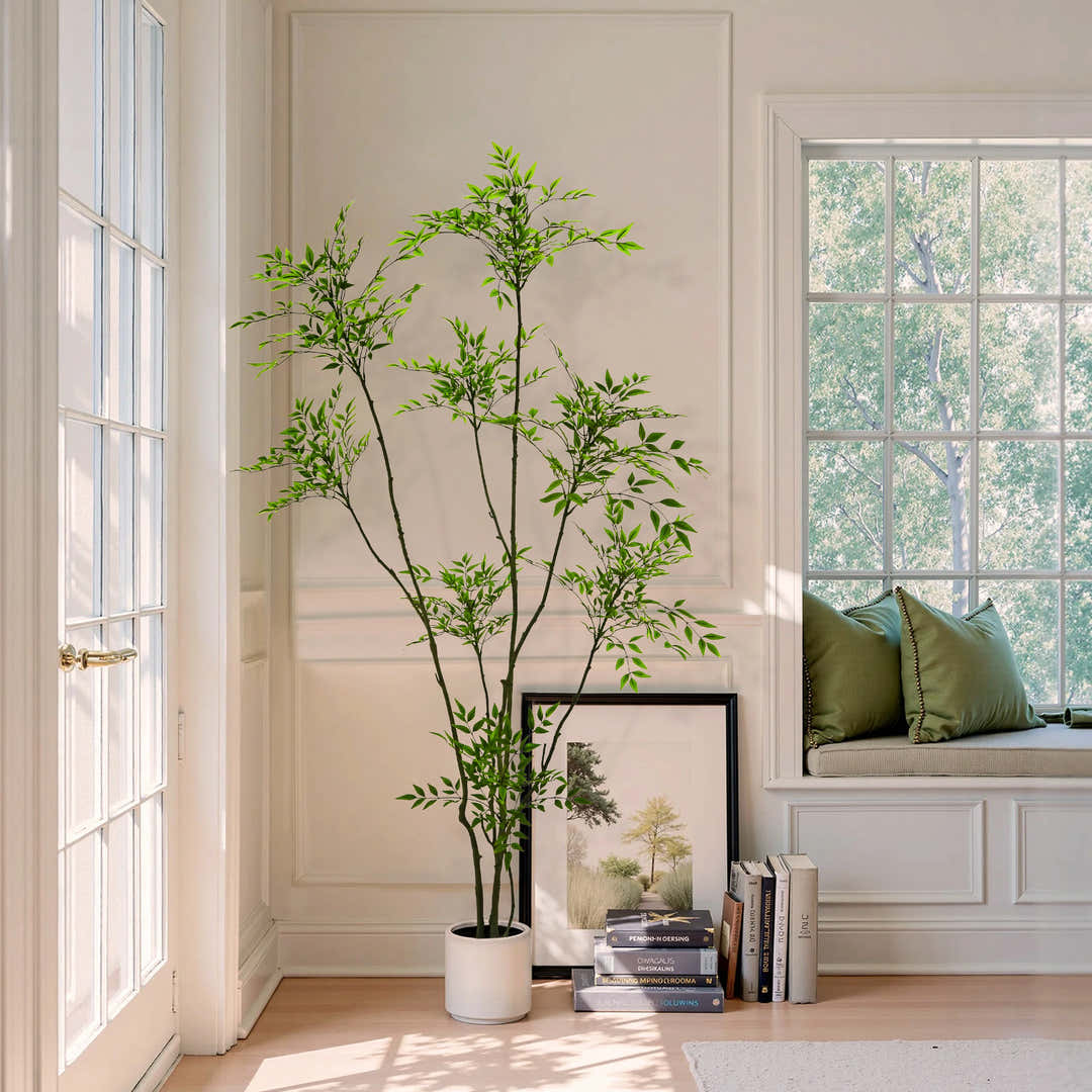 A tall artificial tree used as a focal point in a large room