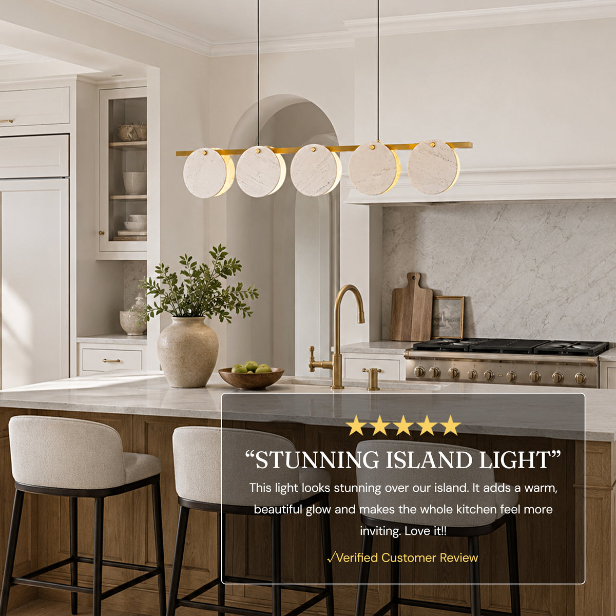 White marble disc linear chandelier above a modern kitchen island