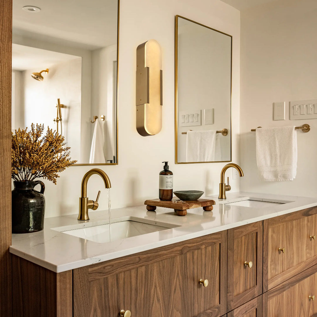 Luxurious gold wall sconce with alabaster shade creating warm ambient lighting